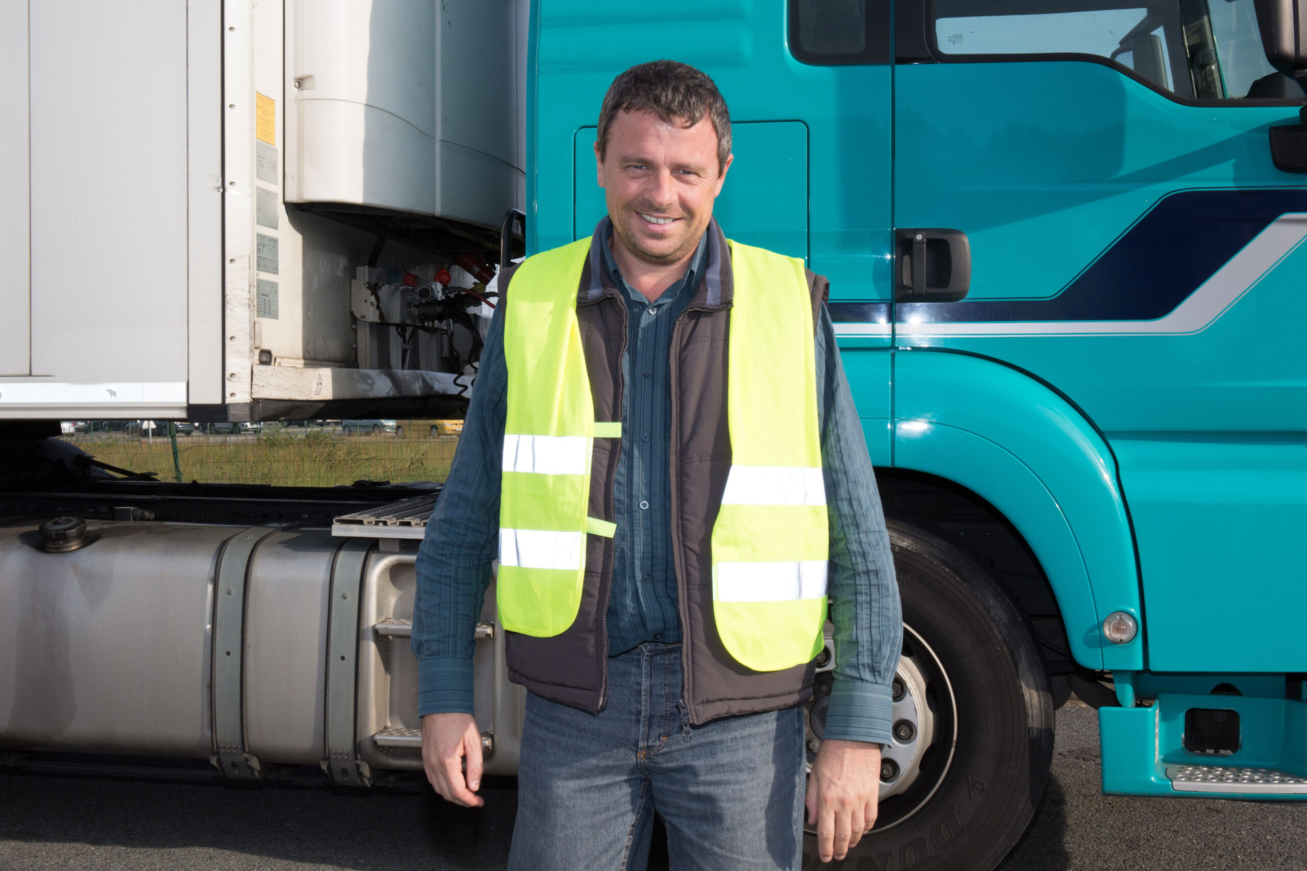 Proud driver in front of a truck